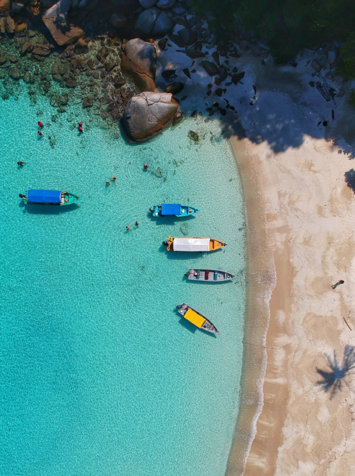 boats in blue water near beach
