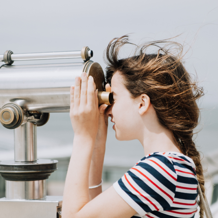 woman observing with binoculars