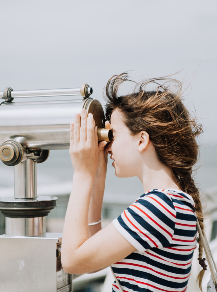 woman observing with binoculars