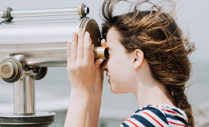 woman observing with binoculars