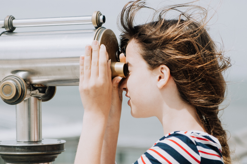 woman observing with binoculars