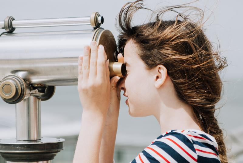 woman observing with binoculars